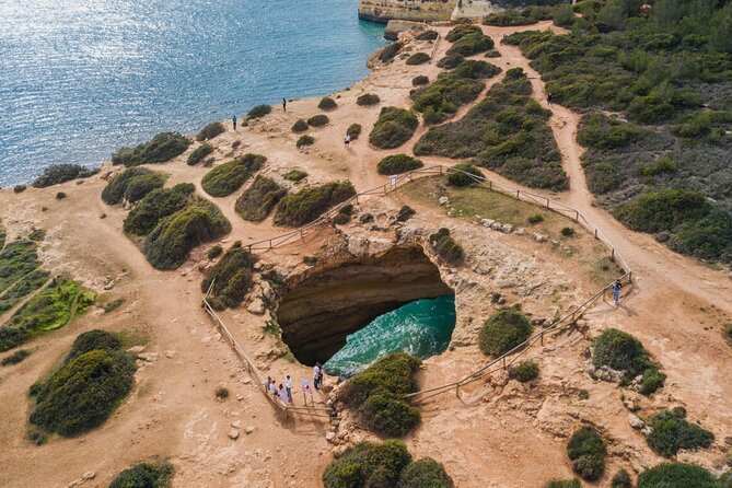 From Albufeira: Benagil Tour, Bones & Medieval Silves Castle - Our Lady of the Rock at Praia de Nossa Senhora da Rocha: cliffs and a chapel with an eerie vibe